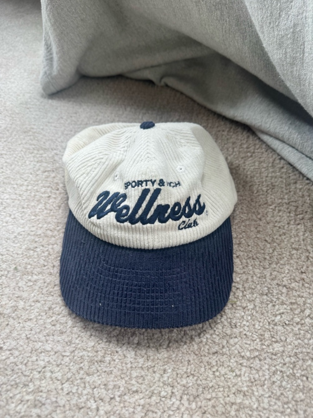 Sporty & Rich Two-Tone Corduroy 'Wellness Club' Cap in Cream and Navy
